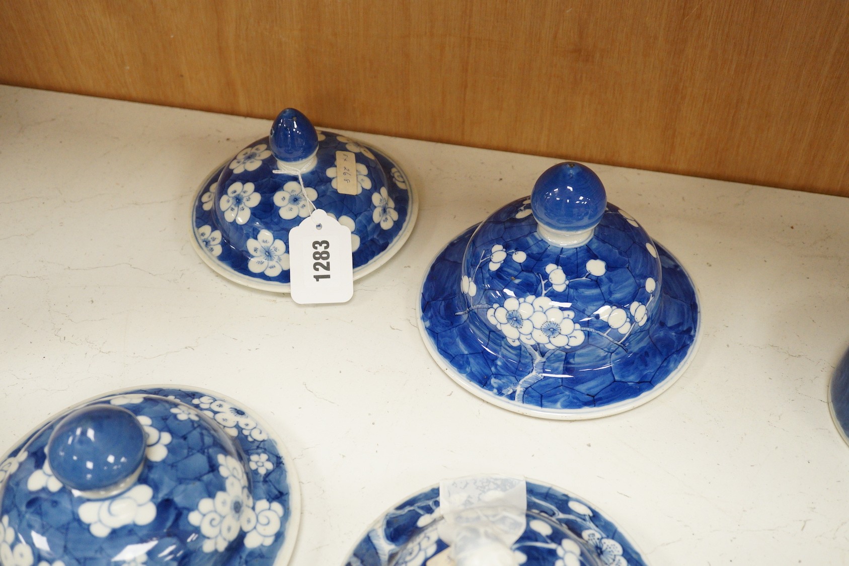 Twelve 18th/19th century Chinese blue and white ‘prunus’ vase and jar covers, largest 17 cm diameter, Provenance - D.C.Monk & Son, former dealers based in Kensington Church Street, London W8